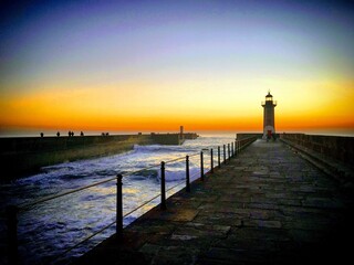 Sunset at the ocean pier with a lighthouse, Porto, Portugal, January 2019 - obrazy, fototapety, plakaty