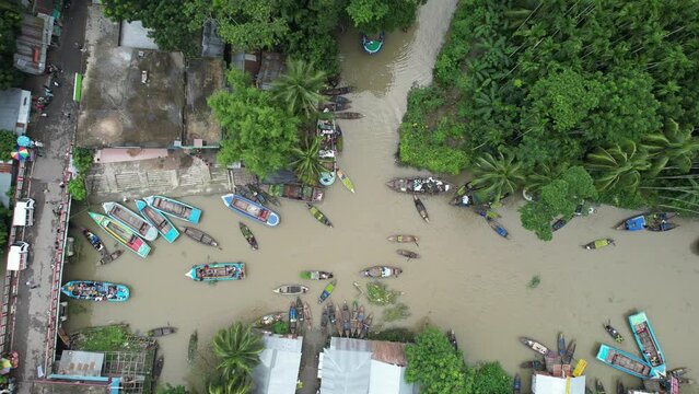 Wooden and metal boats are seen in the river which is the floating market of Bangladesh