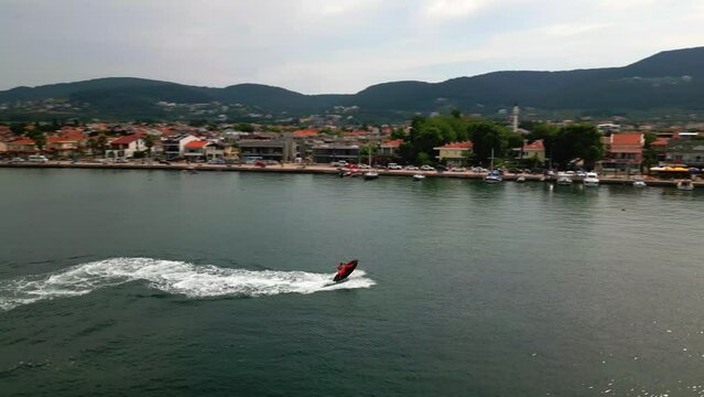 Aerial drone video of jet ski watercraft cruising in high speed at cesmealti urla izmir. High quality 4k footage