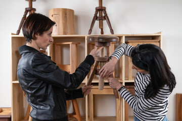 Furniture designer checking quality of a finished wooden chair