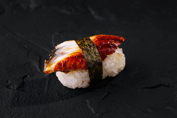 Eel sushi nigiri on black slate