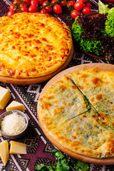 Savory cheese pizzas or khachapuri on rustic table setting
