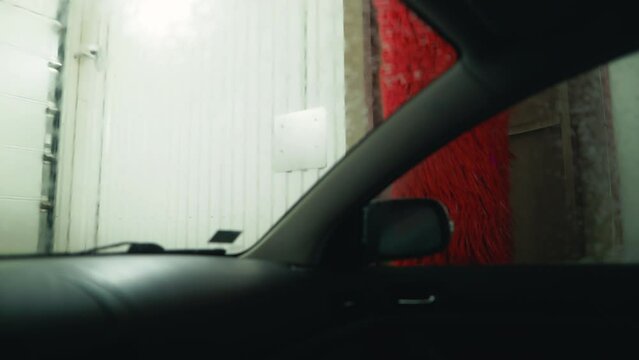Soapy Oasis: Immerse yourself in the tranquil ambiance of an automatic car wash, where foamy waves gently cleanse the vehicle's exterior in captivating slow motion.