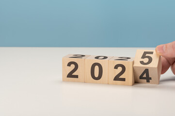2025 happy new year concept, Flipping of wooden cube block change from 2024 to 2025. Wooden cube...