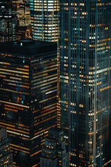 A closeup of skyscrapers in a city during nighttime using a telephoto lens