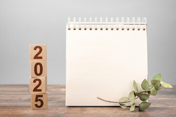 2025 mockup notepad. 2025 cubes wooden table background. New Year. plans for 2025, space for your...