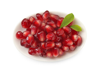 Ripe juicy pomegranate grains and leaves in bowl isolated on white, top view