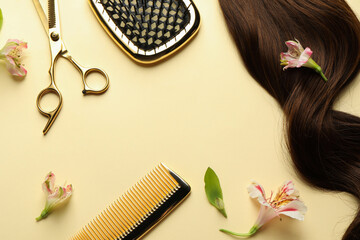 Flat lay composition with different hairdresser tools and flowers on pale yellow background, space...