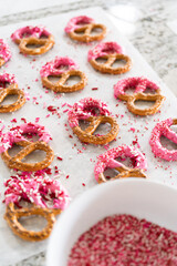 Homemade Gourmet: Delightful Pretzels Adorned with Pink Chocolate and Sprinkles