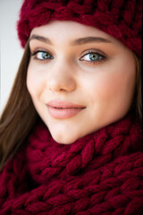 portrait of beautiful young girl in warm knitted scarf