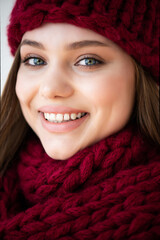 portrait of beautiful young girl in warm knitted scarf