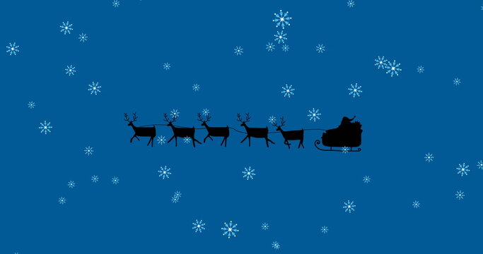 Image of santa claus in sleigh with reindeer over snow falling on blue background