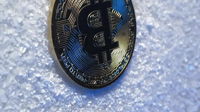 bitcoin gold. snow and bitcoin. Slow motion video. Vertical video. High quality video in 4K format.