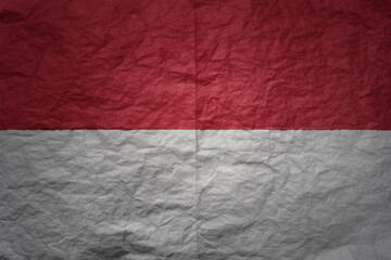 big national flag of indonesia on a grunge old paper texture background