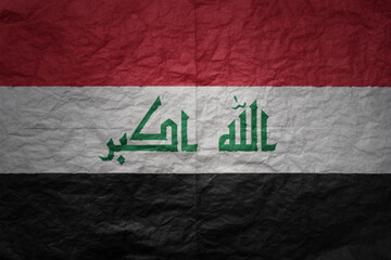big national flag of iraq on a grunge old paper texture background