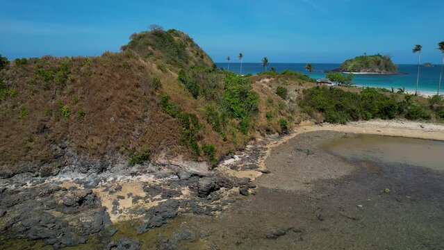 4K Aerial Drone video of Twin beach and Nacpan beach with beautiful sand and palm trees in Calibangbangan, Linapacan, Palawan, Philippines