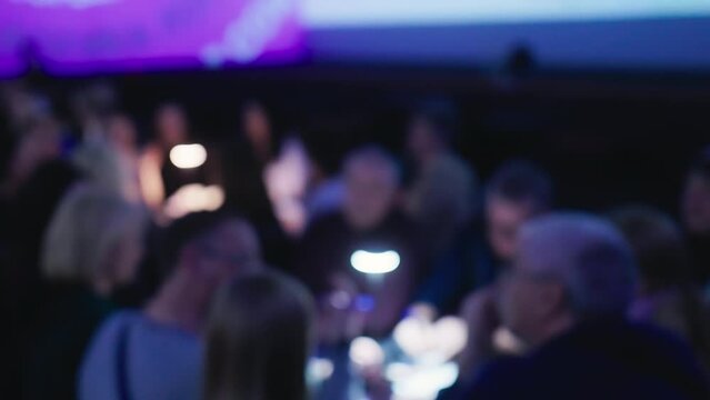 Feel the buzz of excitement as people get caught up in addictive quiz games at a bustling bar, enjoying the challenge and camaraderie