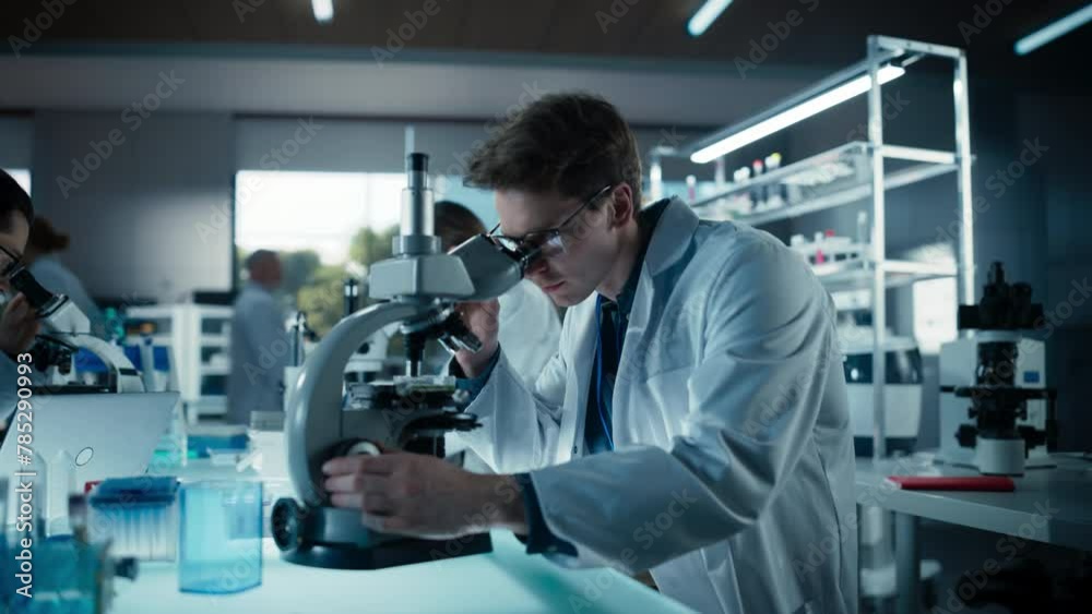Poster molecular biology research scientist looking at dna samples under a microscope in an applied science