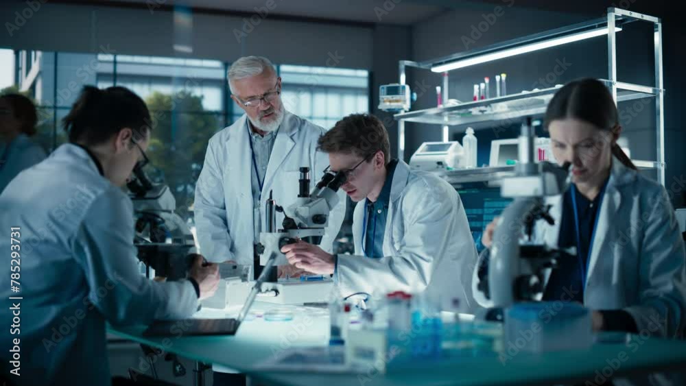 Poster phd professor teaching a group of science students the basics of biological engineering. head of lab