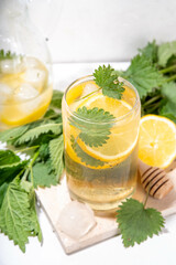 Nettle Tea cold plant drink, iced tea or lemonade. Organic natural herbal tea without caffeine, made with organic raw nettle leaves. Alternative herbal medicine. Stinging nettles, urtica.
