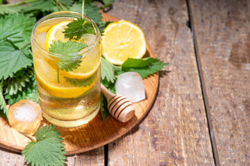 Nettle Tea cold plant drink, iced tea or lemonade. Organic natural herbal tea without caffeine, made with organic raw nettle leaves. Alternative herbal medicine. Stinging nettles, urtica.