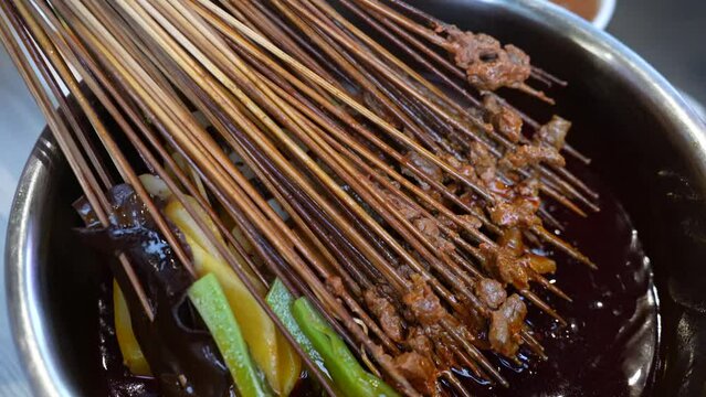 Close-up of traditional Sichuan food, called Chuanchuan, made of skewered vegetables or meat, focused on the food.