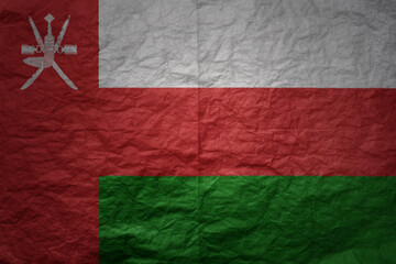 big national flag of oman on a grunge old paper texture background