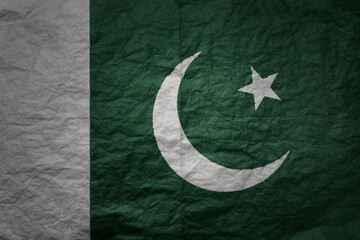 big national flag of pakistan on a grunge old paper texture background