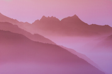 Spectacular mountain ranges silhouettes in shades of pink.