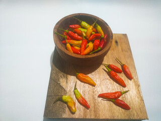 chilies in a small bowl on an isolated white background