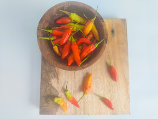 chilies in a small bowl on an isolated white background