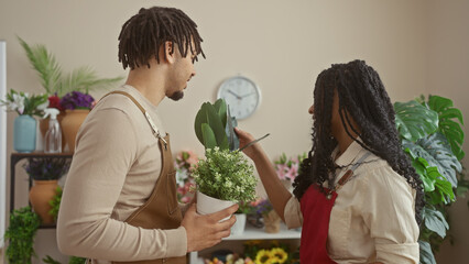 A man and a woman florists collaborate in a flower shop surrounded by diverse plants and decorative items.