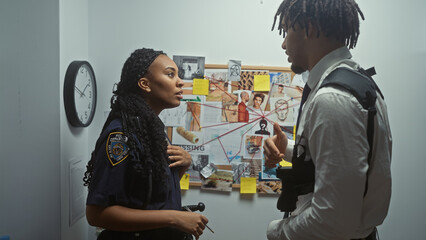 A policewoman and investigator discuss a case in an office with a evidence board