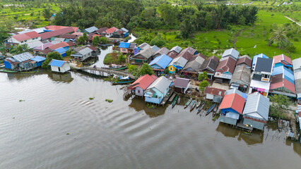 Fototapeta na wymiar View of a residential village on the riverbank of South Kalimantan from a drone during the day