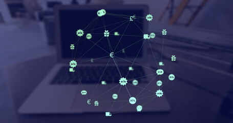 Image of web of connections with icons floating over a laptop computer lying on a table