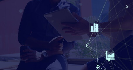 Image of web of connections with icons floating over two people using a digital tablet