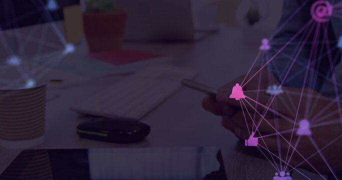 Image of web of connections with icons floating over hands of a man using a smartphone