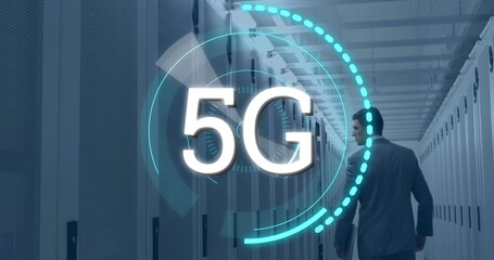 Digital composite of a Caucasian man in suit walking in a corridor of server towers while futuristic