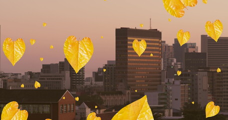 Obraz premium Image of orange autumn leaves falling over cityscape