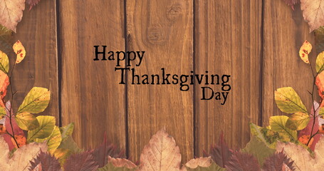Fototapeta premium Image of happy thanksgiving day text over wooden background with autumn leaves