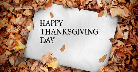 Fototapeta premium Image of happy thanksgiving day text over card with autumn leaves