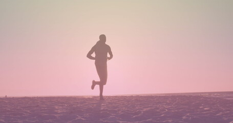 Fototapeta na wymiar Image of over african american man running at beach