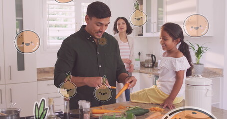 Image of smiling vegetables and fruits over happy biracial father and daughter cooking at home - Powered by Adobe