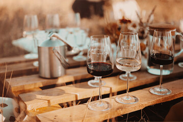 Wooden table with glassware arranged for picnic