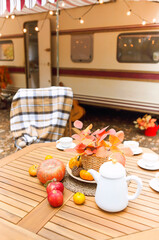 Table and chairs outside trailer in nature