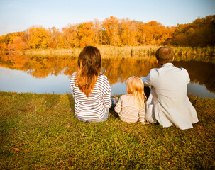 Happy family - mother, father and daughters relaxing at autumn countryside
