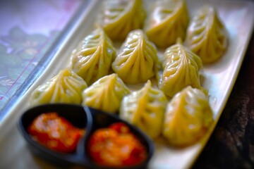photograph of delicious momos with chutney