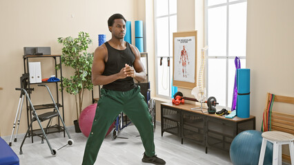 Fototapeta na wymiar An african american man exercising in a physiotherapy clinic, portraying health and fitness.