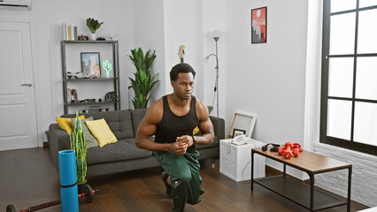 African american man stretching in a modern living room with fitness equipment