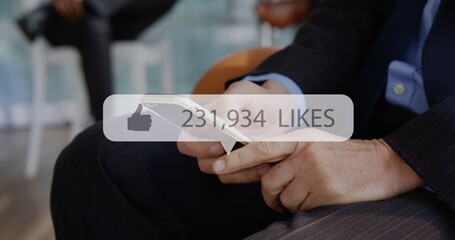 Image of social media like icon and numbers over caucasian man using smartphone
